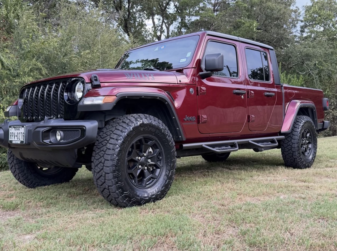Front three-quarter view of Mr. Scott’s burgundy 2022 Jeep Gladiator Willys with Toyo tires and N-Fab steps.